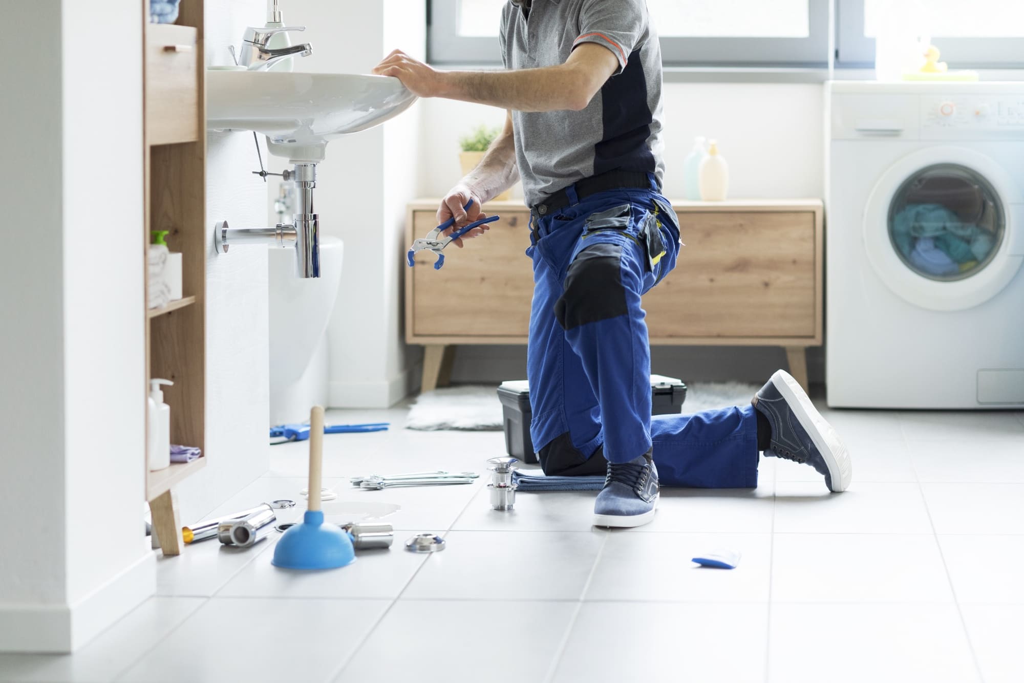Plumber repairing a bathroom sink